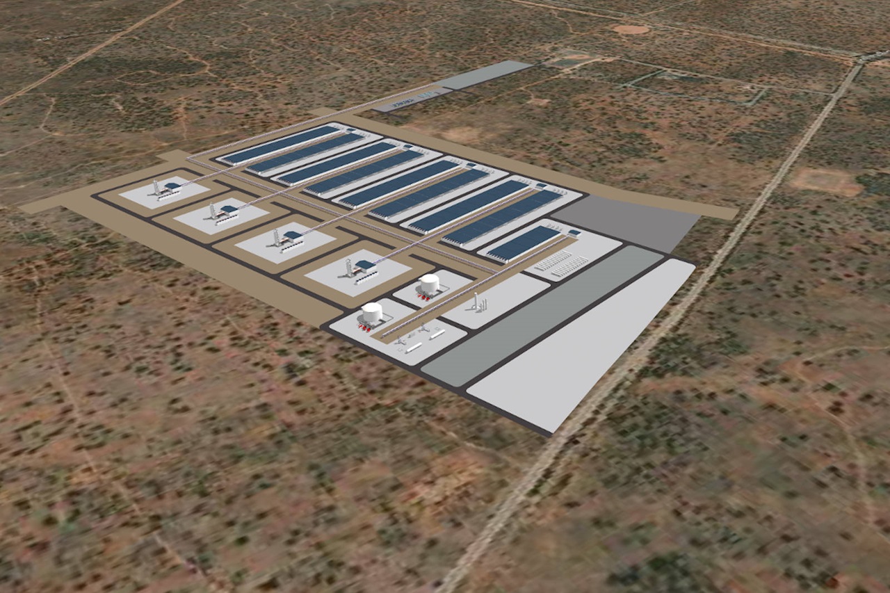 Aerial view of an industrial facility with solar panels, storage tanks, and various structures on a dry landscape.